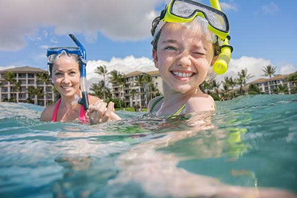 Playful poolside moment capturing family enjoyment and resort guest experience.