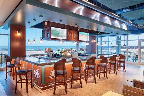 Hospitality bar and lounge capturing atmosphere, materials, and social experience within a resort setting.