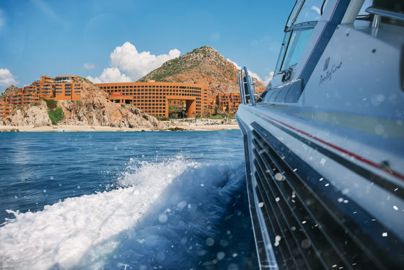 Coastal resort approach from the water highlighting destination scale and travel experience.